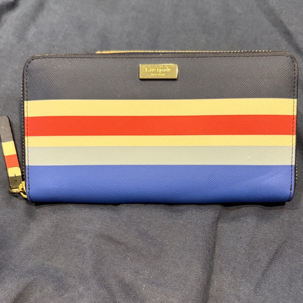 kate spade striped zip-around wallet in navy, blue, red, cream, yellow